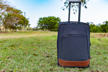 blue suitcase travel with prairie background. executive travel adventure    concept