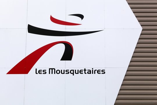 Romaneche, France - March 13, 2018: Les mousquetaires logo on a wall. Les Mousquetaires is a privately owned retailing symbol group based in France and operating internationally