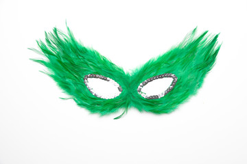 Fancy green feather mask with silver beads isolated in white background	