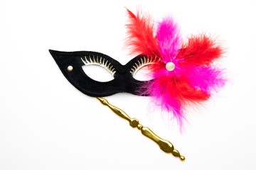 Black festive carnival mask with purple / pink / feathers isolated on a white background	