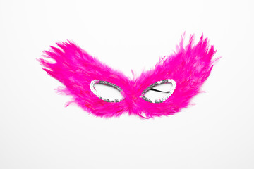 Fancy pink feather mask with silver beads isolated in white background	
