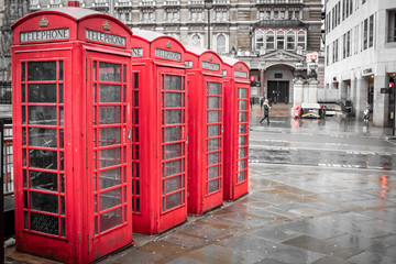 Red vintage phone booths In London United Kingdom on a rainy day