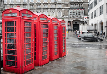 Red vintage phone booths In London United Kingdom on a rainy day