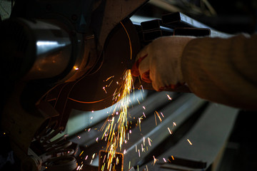 Metal cutting. Grinding steel. Work as a grinder. Sparks from friction. Men's work. Creating a...