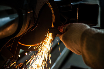 Metal cutting. Grinding steel. Work as a grinder. Sparks from friction. Men's work. Creating a...