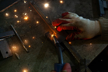 Metal welding. Sparks from electric heating. Work in the workshop. Creation of reliable fastening...