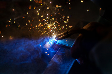 Metal welding. Sparks from electric heating. Work in the workshop. Creation of reliable fastening...