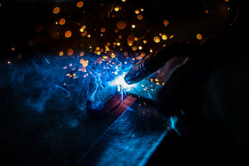 Metal welding. Sparks from electric heating. Work in the workshop. Creation of reliable fastening...