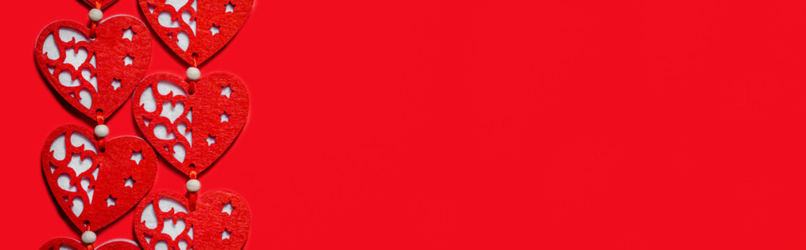 Valentines day concept. Textile red hearts on a red background.