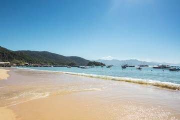 Abraaozinho beach with taxi boat and blue waters in Abraao, on the tropical Ilha Grande, Angra dos Reis, in the south of Rio de Janeiro Brazil