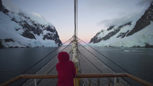 Woman standing on watch on bow or tallship sailboat