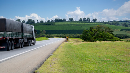 Loaded truck on highway. Scenic country view. Agriculture landscape.