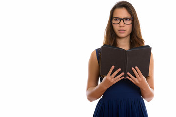 Portrait of young beautiful nerd woman thinking while holding book