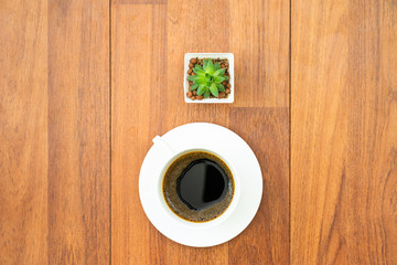 White cup of coffee on wood background
