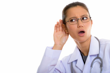 Young beautiful woman doctor listening and thinking
