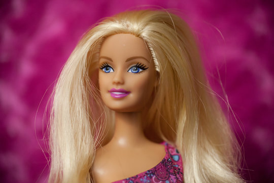 WOODBRIDGE, NEW JERSEY - May 10, 2019: A 2000s era Barbie Doll is posed for a picture on a pink background