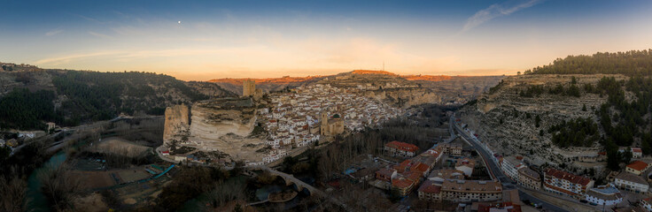 Sunset aerial panorama view of Alcala del Jucar medieval historic village with white washed houses and a castle on a rock in Albacete Spain © tamas