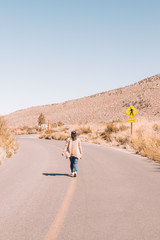 woman on road in desert