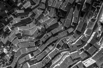 Aerial view of black and white waving, curving rooftops in Alcala del Jucar Albacete Province Spain
