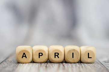 The word April on wooden cubes. Month of year