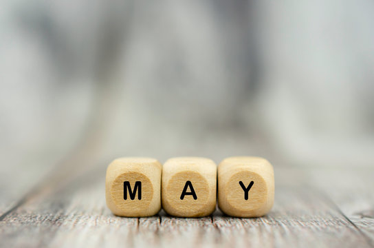 The word May on wooden cubes. Month of year