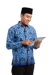 smiling young man wearing batik korpri using pad, government officials of Indonesia