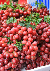 Close-up red wine grapes fruit background at local market.