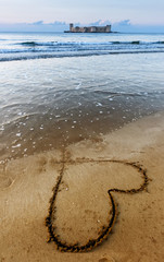 Kizkalesi castle on a small island, Kizkalesi Maiden's Castle near Mersin, Turkey with a heart on the sand