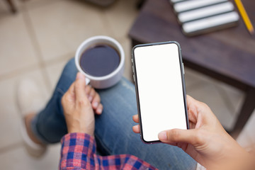 Mockup image blank white screen cell phone.woman hand holding texting using mobile on desk at coffee shop.background empty space for advertise text.people contact marketing business,technology 