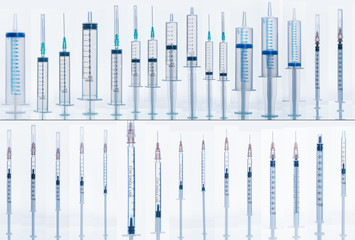 Medical Syringe with needle isolated on white, macro. Many different syringes in different...