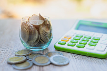Coins in glass bottles lined up from low to high, a natural green background that saves money and financial investment concepts. Retirement age With text input area