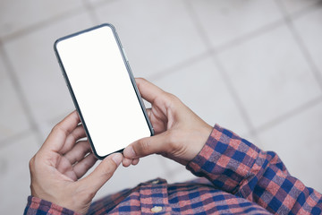 Mockup image blank white screen cell phone.man hand holding texting using mobile on desk at coffee shop.background empty space for advertise text.people contact marketing business,technology 