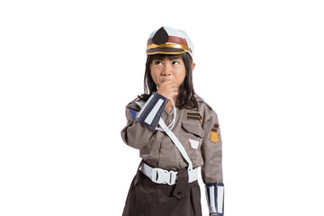asian little girl wearing police uniform with blowing whistle on isolated background