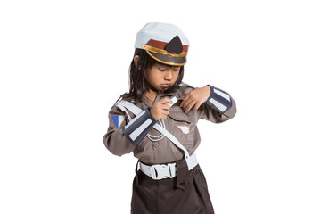 police girl wearing a uniform is putting a whistle in her pocket on white background