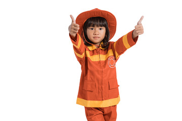 Little girl wearing firefighter uniform with thumbs up hands gesture on white background