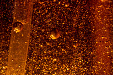 golden liquid abstract background with air bubbles 