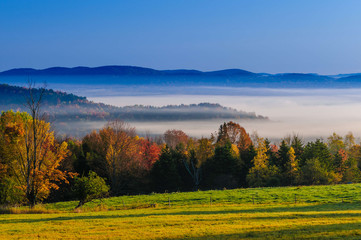 Morning sunrise during fall foliage season, Stowe, Vermont, USA