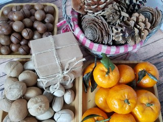 Nuts, tangerines and gifts on a plate