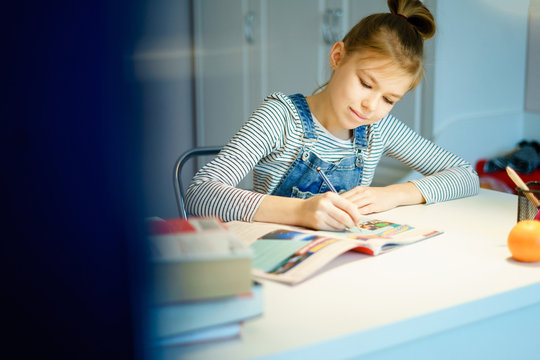 Beautiful Girl Working On Her School Project At Home, Education Concept