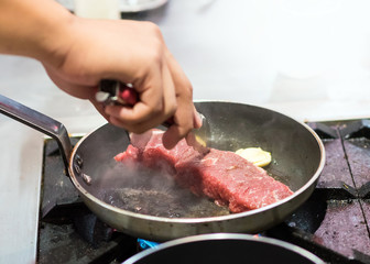Chef cooking, Chef preparing food in the kitchen, Chef decorating dish, closeup.