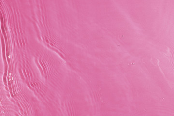 texture of splashing clean water on pink background