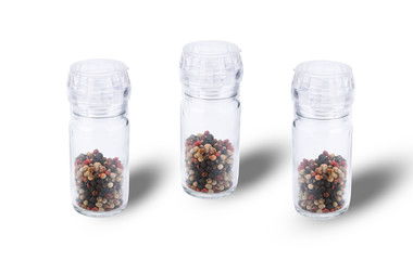 Grain of the colorful pepper in a jar isolated on white background