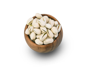 Pistachios in a wooden bowl on a white background.