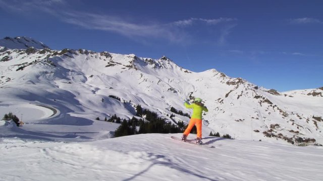 snowboarder girl jumping in a snow park in the Swiss alps. 