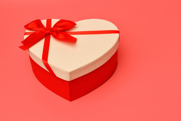 Box. Gift box with a red ribbon on a pink background. Valentine's day and Birthday