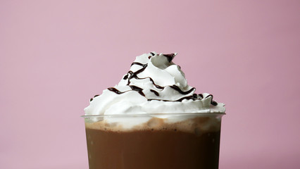 Chocolate topped whip cream Cocoa smoothie on Pink background, Food concept Front view.