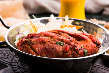Close-up of a plate of chopped tandoori chicken