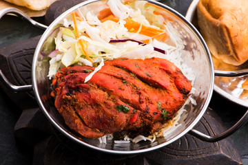 Close-up of a plate of chopped tandoori chicken