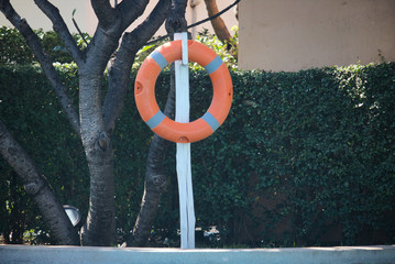 This unique photo shows a lifebuoy in a pool area to keep people safe!