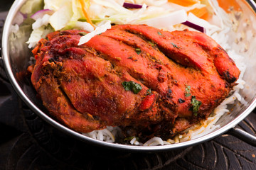 Close-up of a plate of chopped tandoori chicken